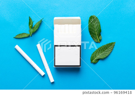 Pack of menthol cigarettes and fresh mint on colored table, Menthol cigarettes top view flat lay 96169418