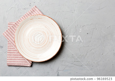 Top view on colored background empty round white plate on tablecloth for food. Empty dish on napkin with space for your design 96169523