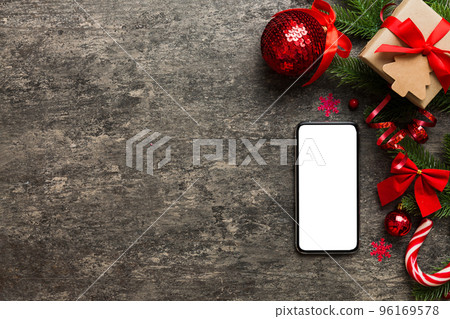 Digital phone mock up with rustic Christmas decorations for app presentation top view with empty space for you design. Christmas online shopping concept. Tablet with copy space on colored background Digital phone mock up with rustic Christmas decorations for app presentation top view with empty space for you design. Christmas online shopping concept. Tablet with copy space on colored background 96169578