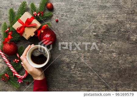Woman holding cup of coffee. Woman hands holding a mug with hot coffee. Winter and Christmas time concept Woman holding cup of coffee. Woman hands holding a mug with hot coffee. Winter and Christmas time concept 96169579