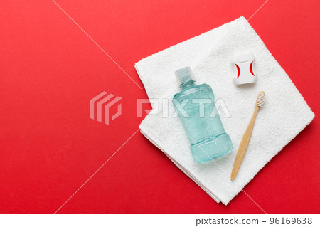 Mouthwash and other oral hygiene products on colored table top view with copy space. Flat lay. Dental hygiene. Oral care products and space for text on light background. concept 96169638