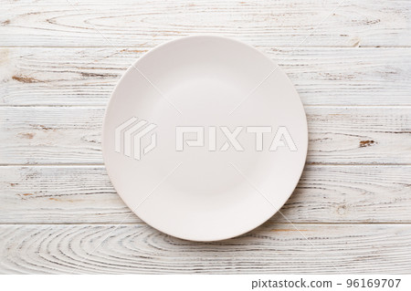 Top view of empty light plate on wooden background. Empty space for your design 96169707