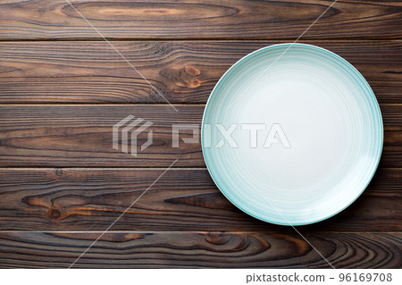 Top view of empty blue plate on wooden background. Empty space for your design Top view of empty blue plate on wooden background. Empty space for your design 96169708