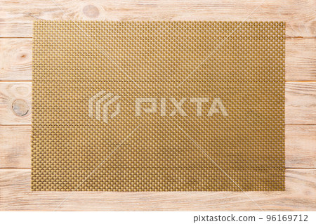 Top view of brown tablecloth for food on wooden background. Empty space for your design Top view of brown tablecloth for food on wooden background. Empty space for your design 96169712