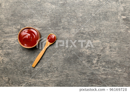 Tasty Tomato Ketchup sauce in wooden bowl with spoon on wood background. Top view with copy space Tasty Tomato Ketchup sauce in wooden bowl with spoon on wood background. Top view with copy space 96169728