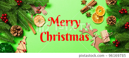 Merry Christmas text. Top view Banner of Christmas decorations on green background. New Year holiday concept with copy space 96169785