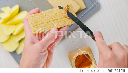 Peanut butter spread on toast bread closeup Peanut butter spread on toast bread closeup 96170156
