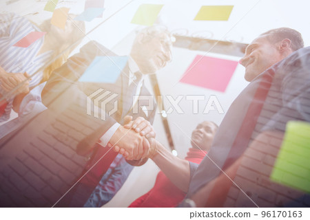 Handshaking business person in office. concept of teamwork and partnership. Handshaking business person in office. concept of teamwork and partnership. 96170163