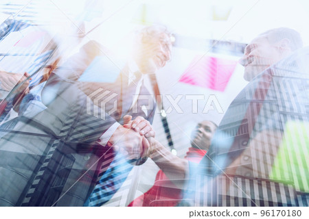 Handshaking business person in office. concept of teamwork and partnership. Handshaking business person in office. concept of teamwork and partnership. 96170180