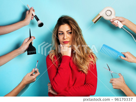 Woman thinks to do makeup and hair style. Concept of beauty and fashion Woman thinks to do makeup and hair style. Concept of beauty and fashion 96170337
