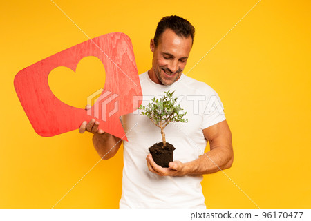 Happy man likes a small tree ready to be planted. concept of forestation 96170477