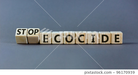 Stop ecocide symbol. Turned wooden cubes with words stop ecocide. Beautiful grey background, copy space. Business, ecological and stop ecocide concept. 96170939