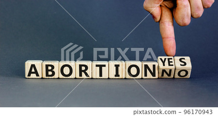 Abortion yes or no symbol. Concept words Abortion yes or Abortion no on wooden cubes. Doctor hand. Beautiful grey table grey background. Abortion yes or no Roe versus Wade concept. Copy space. Abortion yes or no symbol. Concept words Abortion yes or Abortion no on wooden cubes. Doctor hand. Beautiful grey table grey background. Abortion yes or no Roe versus Wade concept. Copy space. 96170943