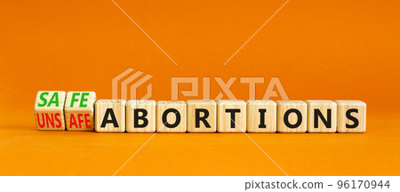 Safe or unsfe abortions symbol. Concept words Safe abortions and Unsfe abortions on wooden cubes. Beautiful orange table orange background. Medical safe or unsfe abortions concept. Copy space. Safe or unsfe abortions symbol. Concept words Safe abortions and Unsfe abortions on wooden cubes. Beautiful orange table orange background. Medical safe or unsfe abortions concept. Copy space. 96170944