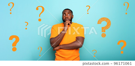 Confuse and pensive expression of a boy with many questions . cyan colored background 96171061