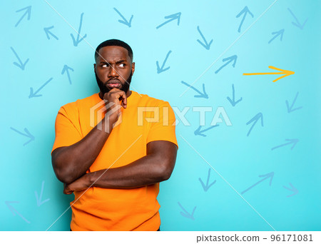 Confused Man have to choose the right arrow to follow. Concept of options, confusion, decision. Confused Man have to choose the right arrow to follow. Concept of options, confusion, decision. 96171081