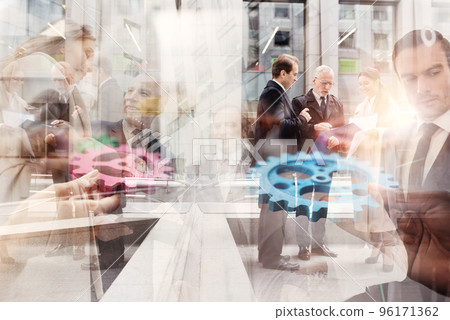 Business team connect pieces of gears. Teamwork, partnership and integration concept. double exposure 96171362
