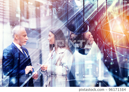 Handshaking business person in office. concept of teamwork and partnership. Double exposure 96171384