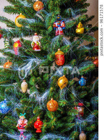 New Year and Christmas decorations hang on xmas tree at home New Year and Christmas decorations hang on xmas tree at home 96171578