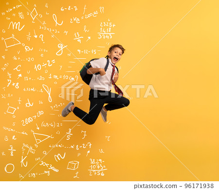 Young boy student runs fast to escape from school. Yellow background Young boy student runs fast to escape from school. Yellow background 96171938
