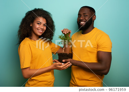 Happy couple protect a small tree. Concept of forestation, ecology and conservation 96171959