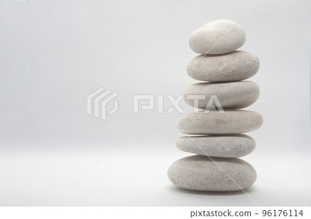 Zen stones stacking on white background with customizable space for text or ideas. Copy space. 96176114