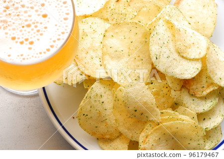 Nori salty potato chips and a glass of cold beer 96179467