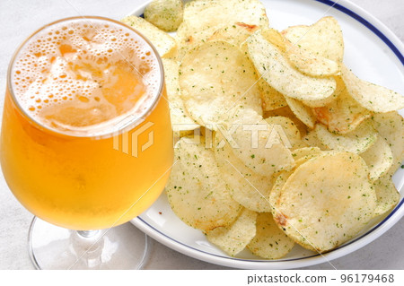 Nori salty potato chips and a glass of cold beer 96179468