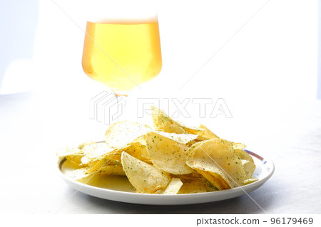 Nori salty potato chips and a glass of cold beer Nori salty potato chips and a glass of cold beer 96179469