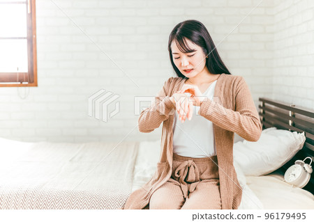 Japanese woman suffering from rough hands and eczema in bed Japanese woman suffering from rough hands and eczema in bed 96179495