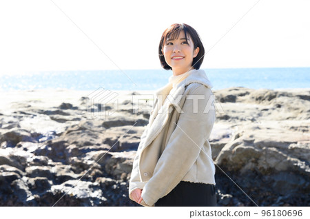 Woman enjoying the sea of Enoshima in winter 96180696
