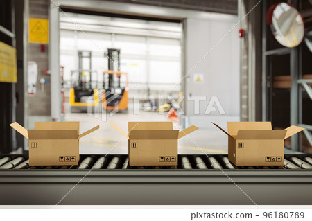 Cardboard boxes on conveyor rollers inside a warehouse ready to be shipped by courier for distribution 96180789