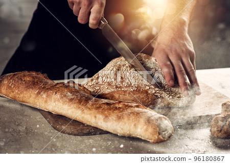 Baker with bread just out of the oven 96180867