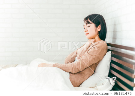 Japanese woman suffering from throat, tonsils and neck in bedroom Japanese woman suffering from throat, tonsils and neck in bedroom 96181475