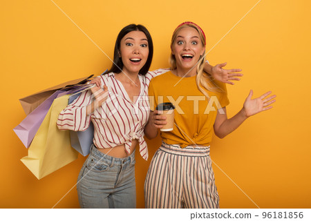 Happy friend girls are amazed about a shop sales. surprised expression 96181856