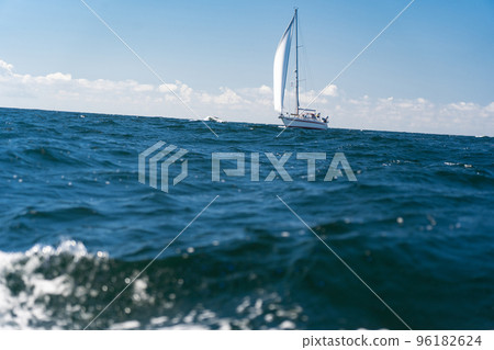 Sailboat on blue open sea with clouds on sky. Concept of travel, adventure and vacation. 96182624