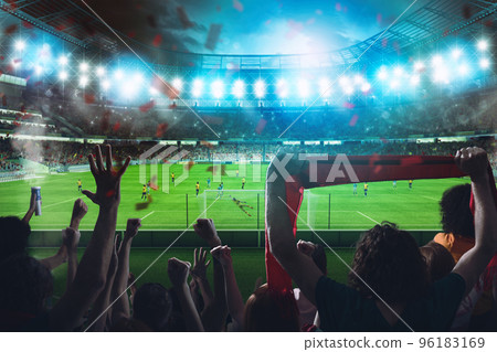 Football scene at night match with cheering fans at the stadium Football scene at night match with cheering fans at the stadium 96183169