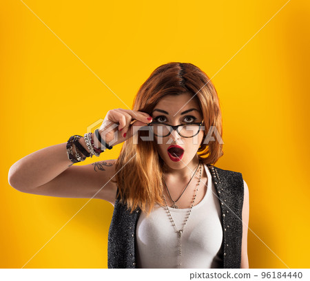 Girl has a shocked expression on yellow background 96184440