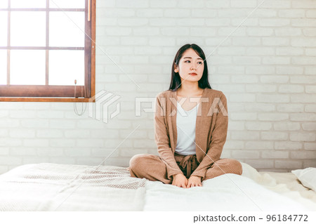 A Japanese woman in pajamas who suffers from depression, boredom, and trouble in her bedroom 96184772