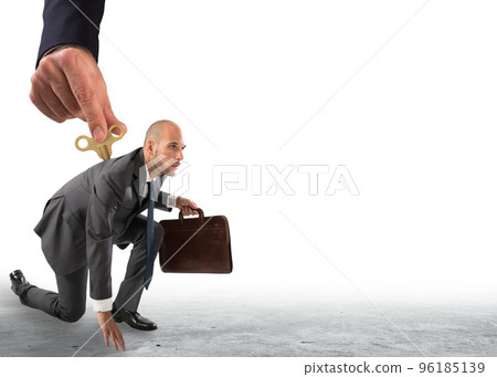 Hand from above giving the charge to a businessman ready to go. 96185139