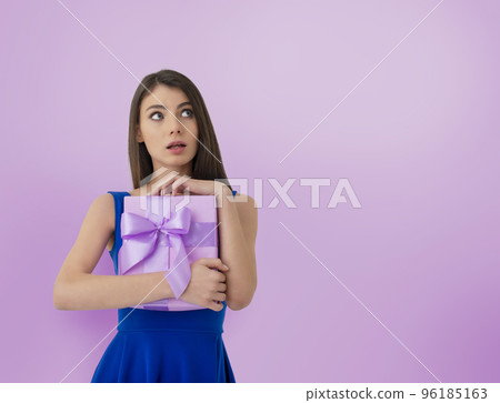 Happy woman think about her received present Happy woman think about her received present 96185163