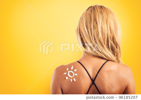 Girl in swimsuit with a sun made with sunscreen. Girl in swimsuit with a sun made with sunscreen. 96185207