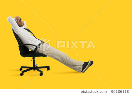 Businessman relax and think sitting on a chair. Yellow background Businessman relax and think sitting on a chair. Yellow background 96186118