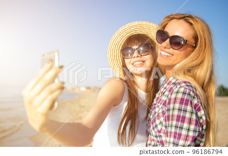 Happy group of friend makes a selfie with a mobile phone. 96186794