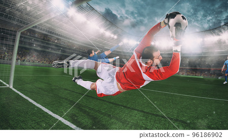 Goalkeeper catches the ball in the stadium during a football game 96186902