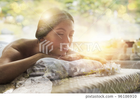 Woman relaxing with a massage in a spa center. Double exposure 96186910