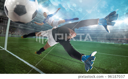 Goalkeeper catches the ball in the stadium during a football game Goalkeeper catches the ball in the stadium during a football game 96187037