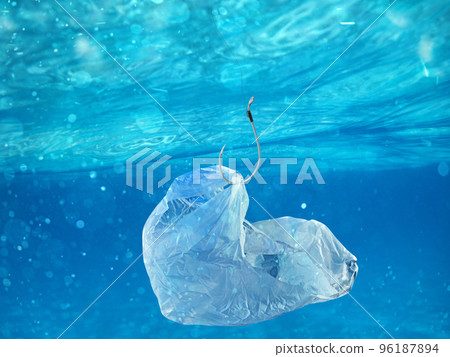 Floating bag. Problem of plastic pollution under the sea concept. Floating bag. Problem of plastic pollution under the sea concept. 96187894