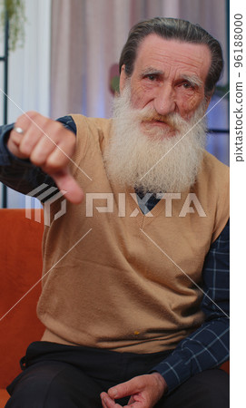 Upset senior man showing thumbs down, dislike bad work, disapproval, dissatisfied feedback at home Upset senior man showing thumbs down, dislike bad work, disapproval, dissatisfied feedback at home 96188000