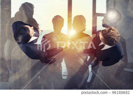 Handshaking business person in office. concept of teamwork and partnership. Double exposure 96188682